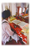 Granthi sits before Guru Granth Sahib