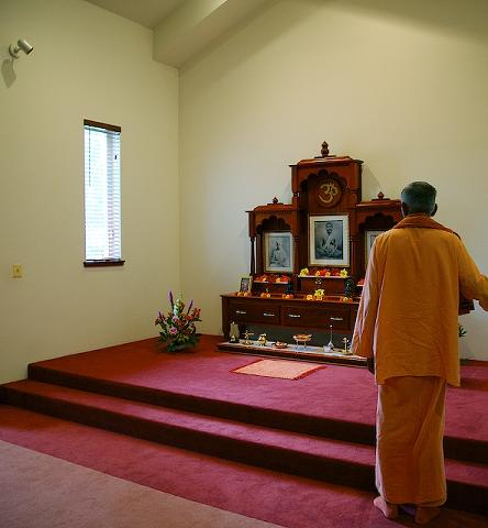 a monk approaches the altar at the Vedanta Center