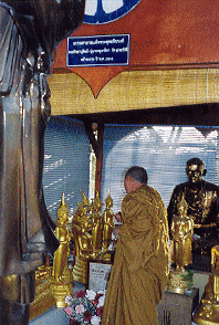 Monk in the outdoor shrine