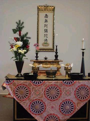 Close up of altar setting with NEMBUTSU scroll on back wall